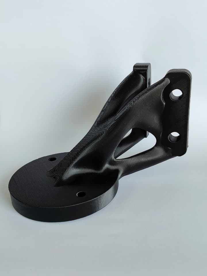 Topology optimised outdoor bracket 3D printed in ASA-CF for an electronic component, rated 100 N